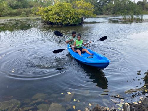 two young boys in a blue kayak on a river at Seth Villa by Magampura Resorts in Tangalle