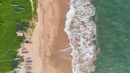 an overhead view of a beach with boats in the water at Seth Villa by Magampura Resorts in Tangalle