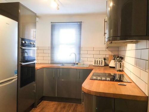 a kitchen with a sink and a counter top at Lux Home Stays - Regents Place in Leamington Spa