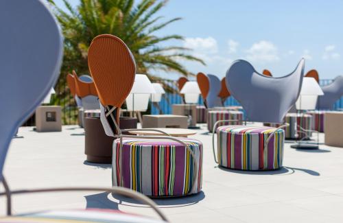 a row of chairs and suitcases on a patio at Bluesun Hotel Jadran in Tučepi