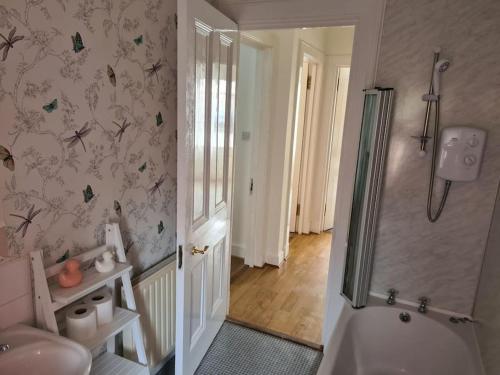 a bathroom with a shower and a sink and a toilet at Cosy home in Stornoway