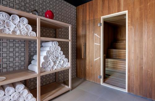 a cupboard filled with white plates in a room at Bluesun Hotel Jadran in Tučepi