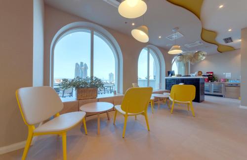 a room with a table and chairs and windows at Bluesun Hotel Jadran in Tučepi