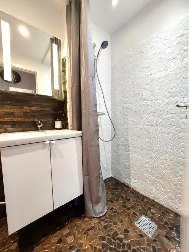a bathroom with a sink and a shower with a shower curtain at Central Nordic style apartment in Aalborg in Aalborg