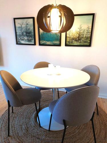 a meeting room with a white table and chairs at Central Nordic style apartment in Aalborg in Aalborg