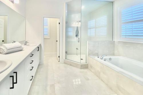 a white bathroom with a tub and a shower at Snow Valley Hideaway in Barrie