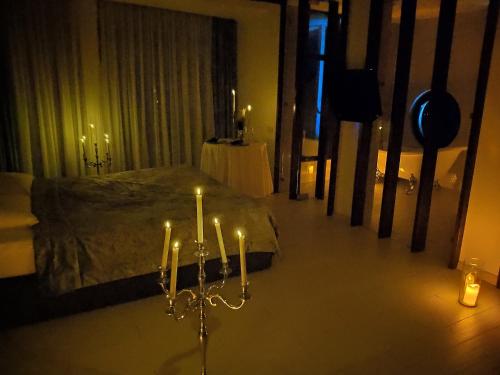 a bedroom with a bed with candles in it at Design Hotel Skopeli in Odesa