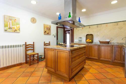 a large kitchen with wooden cabinets and a counter top at Villa Sanchez in Campos