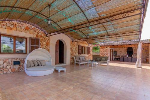 a large living room with a stone wall at Villa Sanchez in Campos