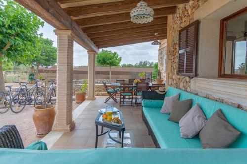 a blue couch on a patio with a table at Villa Sanchez in Campos