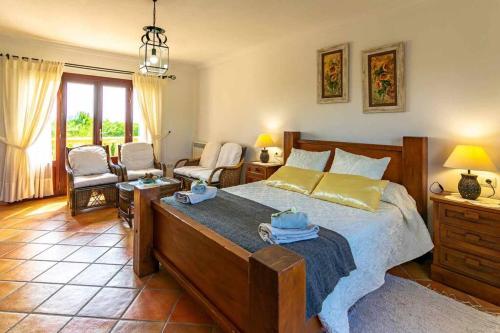 a bedroom with a large bed and a living room at Villa Sanchez in Campos