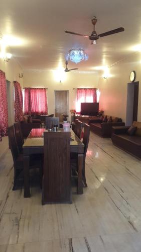a living room with a table and a couch at Quinte Hills Residency in Panchgani