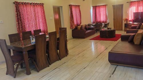a living room with a table and a couch at Quinte Hills Residency in Panchgani