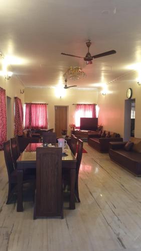 a living room with a table and a couch at Quinte Hills Residency in Panchgani