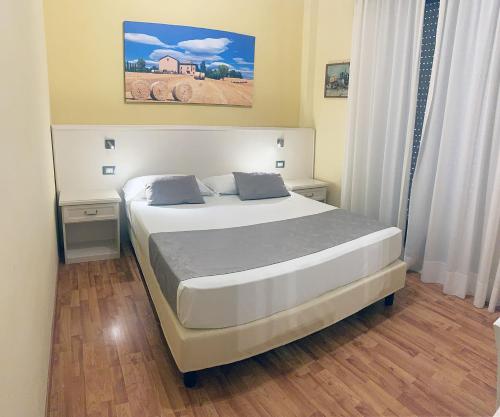 a bedroom with a large bed in a room at Hotel Rabay in Brenzone sul Garda