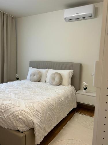 a bedroom with a bed with a white comforter at Casa di Ale Venezia in Mestre