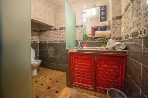 a bathroom with a red door and a toilet at Riad Fes Hayat - Confort Stay in Fès