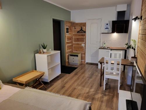 a living room with a kitchen and a dining room table at Old Town Apartment in Valga