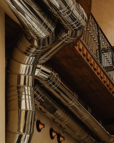 a spiral staircase in a building with a metal railing at Hotel Copernicus in Kraków