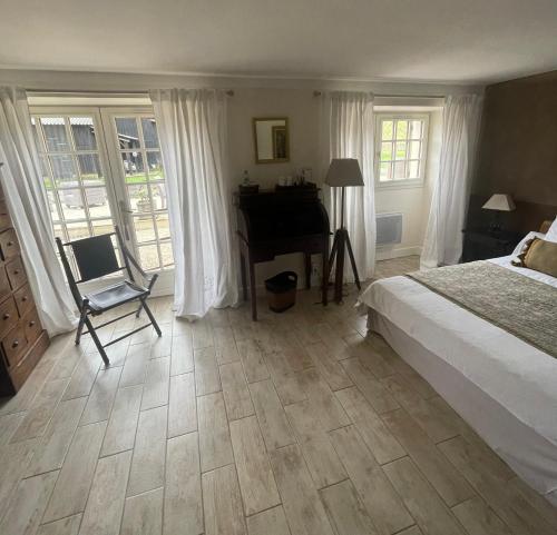 a bedroom with a bed and a desk and a piano at Moulin de Laboirie in Bazas