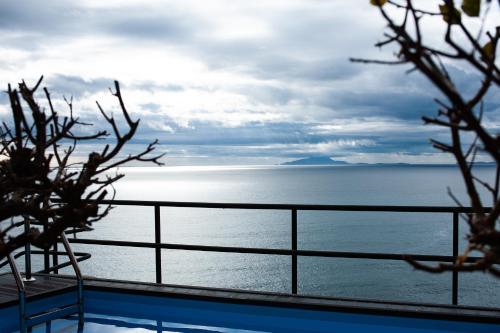 a view of the ocean from a house balcony at Villa Margi in Vico Equense