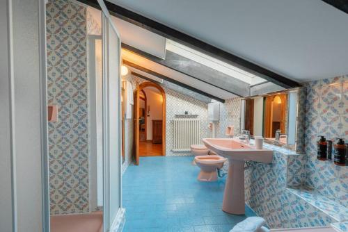 a bathroom with two toilets and a sink and a shower at Loft Glicine, by R Collection apartment in Brienno