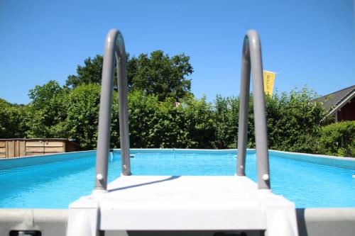 a chair sitting in front of a swimming pool at Camping de Kuilen in Someren