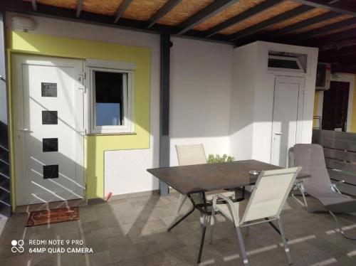a patio with a table and chairs and a door at Ellena Sunshine in Opatija