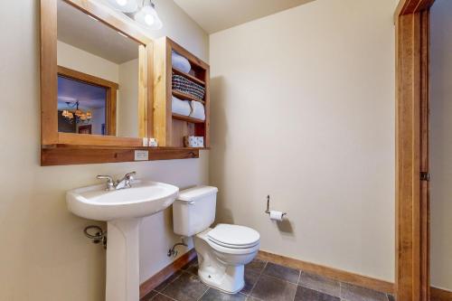 a bathroom with a toilet and a sink and a mirror at Red Hawk Lodge 2200 in Dillon