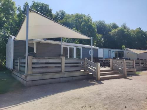 a mobile home with a porch and a canopy at Modern 6P Tiny SolHouse 6 - Near Groningen in Kropswolde