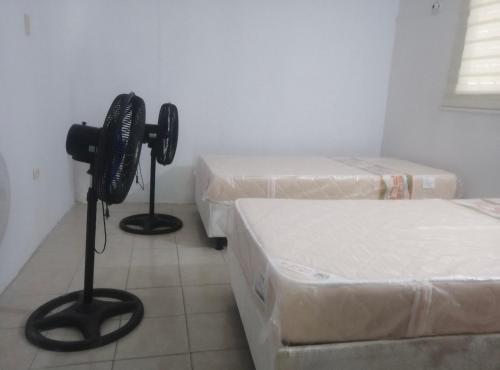 a room with two mattresses and two beds in it at House prado in Barranquilla