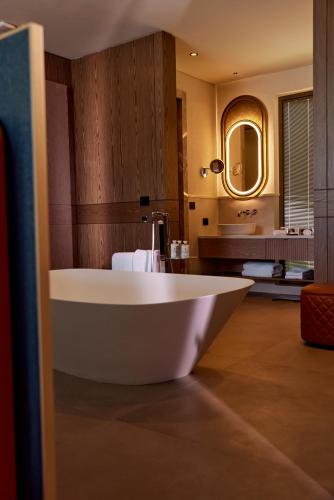 a large bath tub in a bathroom with a mirror at Bayou Villas Antalya - Ultra All Inclusive in Antalya
