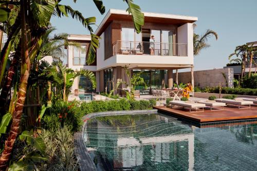 a house with a swimming pool in front of a house at Bayou Villas Antalya - Ultra All Inclusive in Antalya