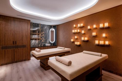 a room with two beds and lights on the wall at Bayou Villas Antalya - Ultra All Inclusive in Antalya