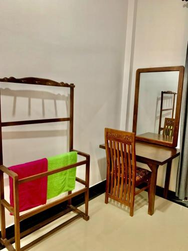 a bedroom with a desk and a chair and a mirror at Ocean Bliss Villa Mirissa in Kamburugamuwa