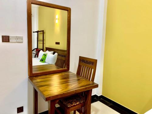 a mirror on a wooden table in a room at Ocean Bliss Villa Mirissa in Kamburugamuwa