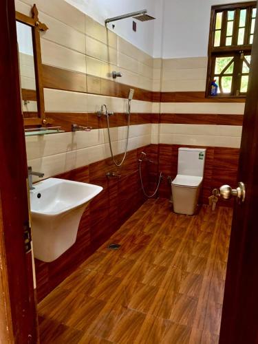 a bathroom with a sink and a toilet at Ocean Bliss Villa Mirissa in Kamburugamuwa
