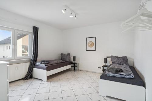 a bedroom with two beds and a window at SU01 Wohnung in Klein-Gerau! in Büttelborn