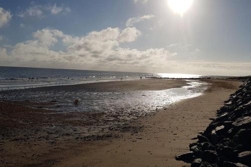a beach with the sun shining on the water at L'Ancre du Bessin - Proximité Bayeux et plages du débarquement - D-DAY - Spa en option - Accessible PMR in Saint-Vigor-le-Grand