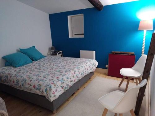 a bedroom with a bed and a blue wall at L'Ancre du Bessin - Proximité Bayeux et plages du débarquement - D-DAY - Spa en option - Accessible PMR in Saint-Vigor-le-Grand