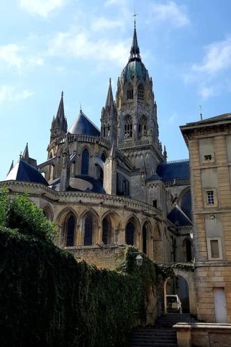 a large building with a staircase in front of it at L'Ancre du Bessin - Proximité Bayeux et plages du débarquement - D-DAY - Spa en option - Accessible PMR in Saint-Vigor-le-Grand