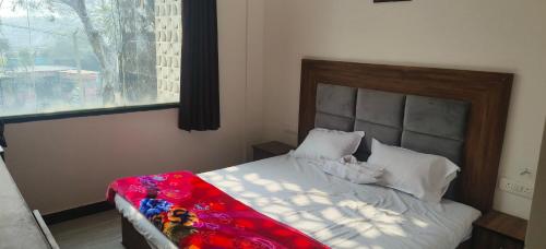 a bedroom with a bed with a large window at MD Grand Hotel and resort in Agra