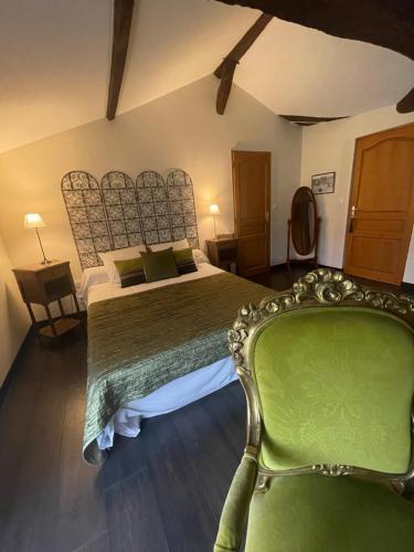 a bedroom with a green bed and a green chair at Moulin de Laboirie in Bazas