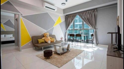 a living room with a teddy bear sitting on a couch at Ber-Santai at Sutera Avenue in Kota Kinabalu