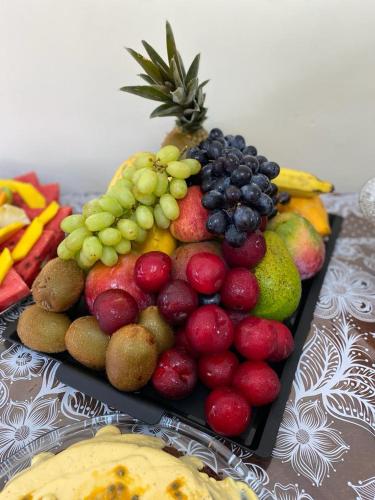 a tray of fruit on top of a table at Pousada Amendoeira in Mangaratiba