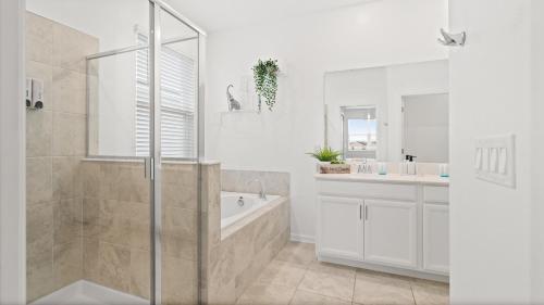 a white bathroom with a tub and a sink at Stylish Condo 3Beds 2Baths 18Min from Disney in Kissimmee