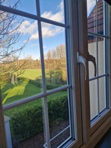 a window looking out at a view of a yard at The Star in West Leake