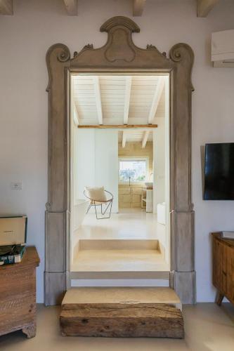 a large mirror in a room with a table at Palazzo Sant'Anna Lecce in Lecce