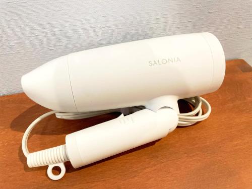 a white hair dryer sitting on top of a table at EN HOTEL Kyoto in Kyoto