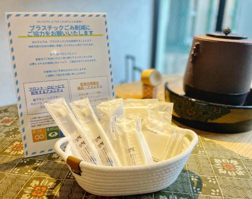 a bowl of chopsticks sitting on a table with a hat at EN HOTEL Kyoto in Kyoto